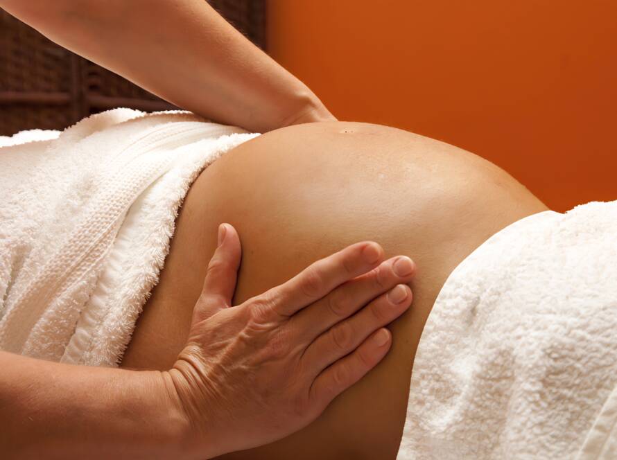 Prenatal massage targeting legs to reduce swelling and discomfort