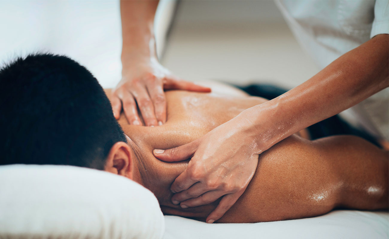 close-up of therapist applying deep pressure during deep tissue massage