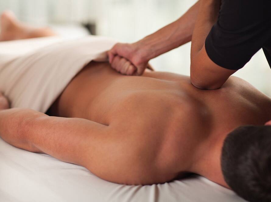 Peaceful massage room with soft lighting prepared for a deep tissue treatment