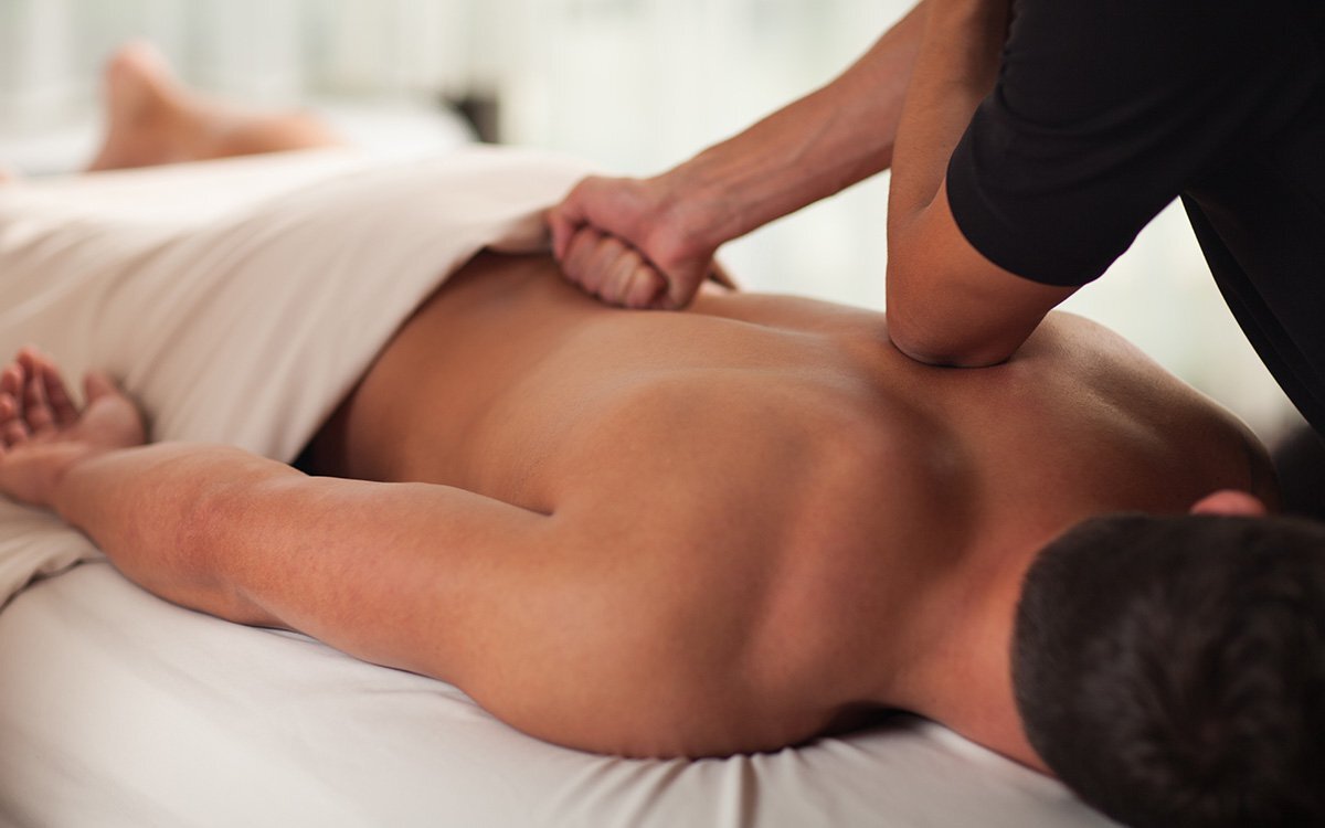 Peaceful massage room with soft lighting prepared for a deep tissue treatment