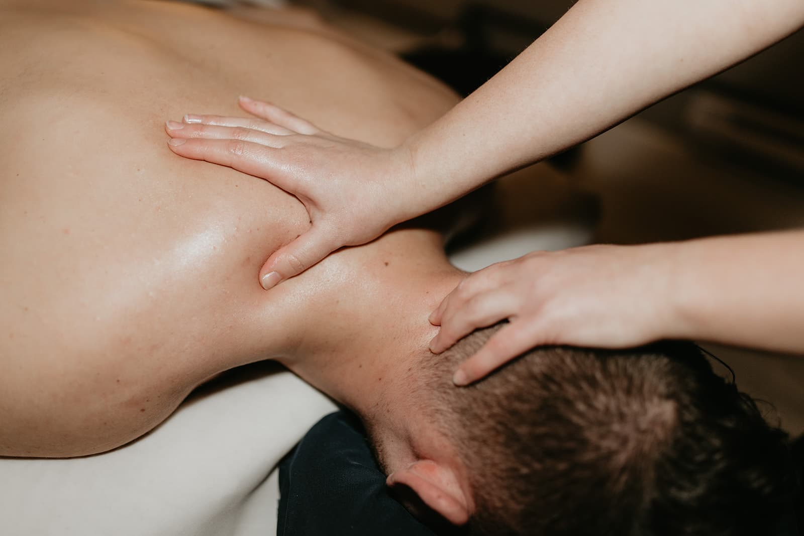 Registered massage therapist performing Rapid NeuroFascial Reset treatment on client at Rowan & Peridot Collective