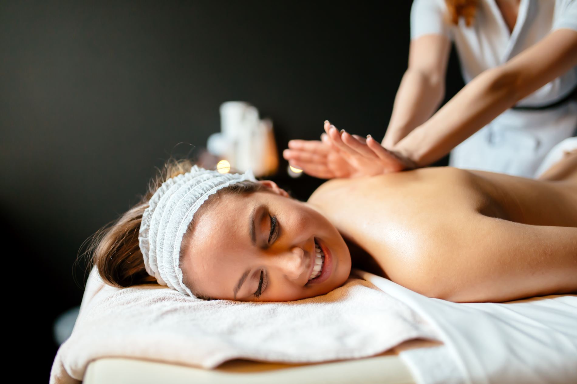 Close-up of hands kneading shoulder muscles