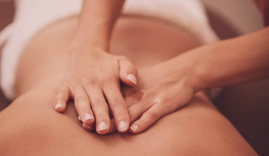Client relaxing in a peaceful spa environment during Swedish massage