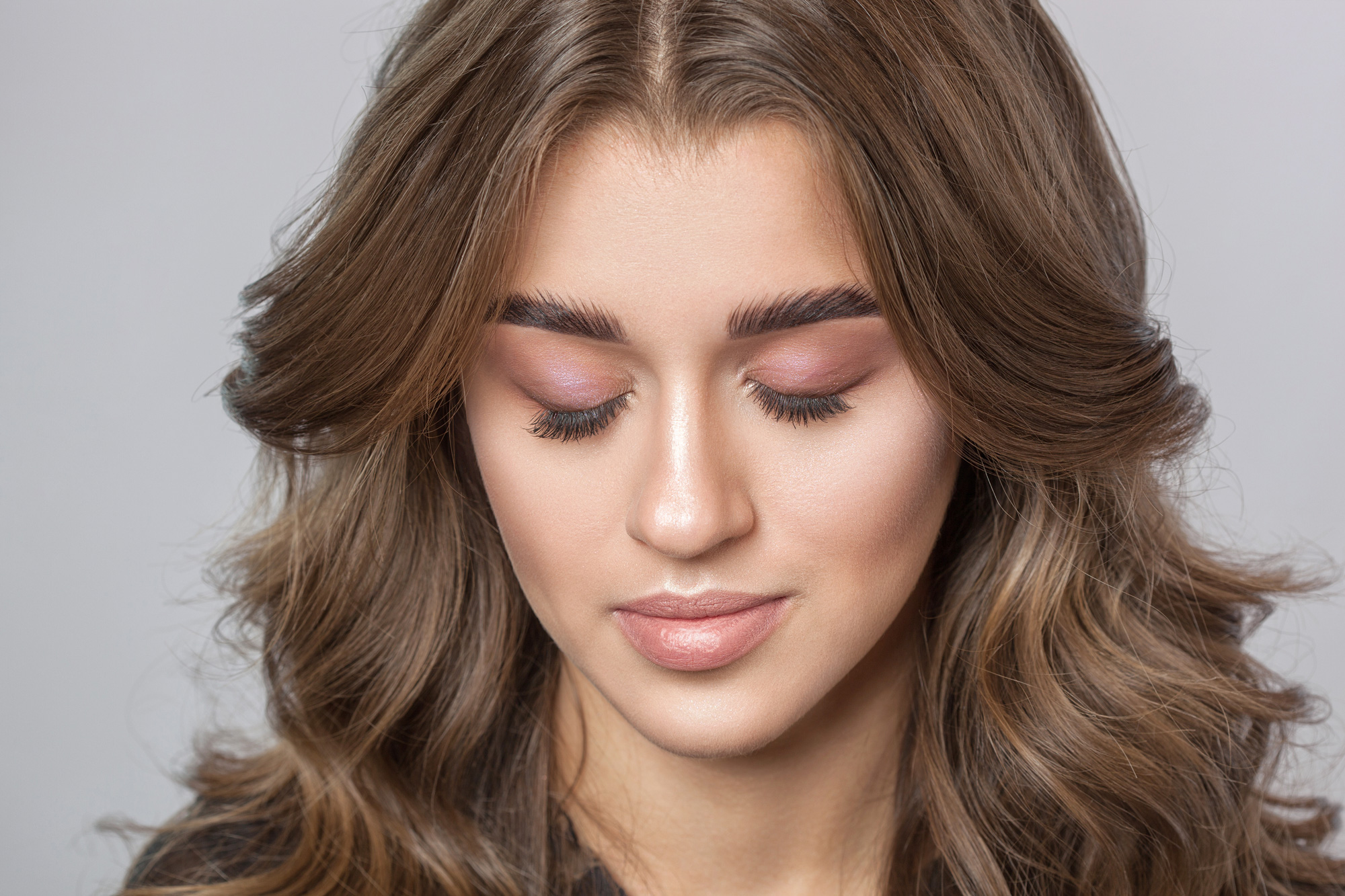 Before and after eyelash lamination showing lifted natural lashes with a soft curled finish