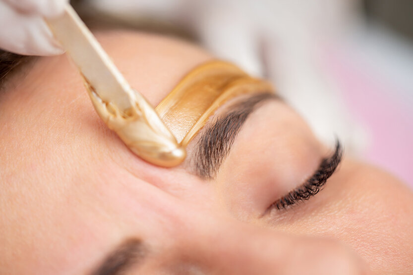 Eyebrow waxing treatment shaping and defining natural brows at our lethbridge location