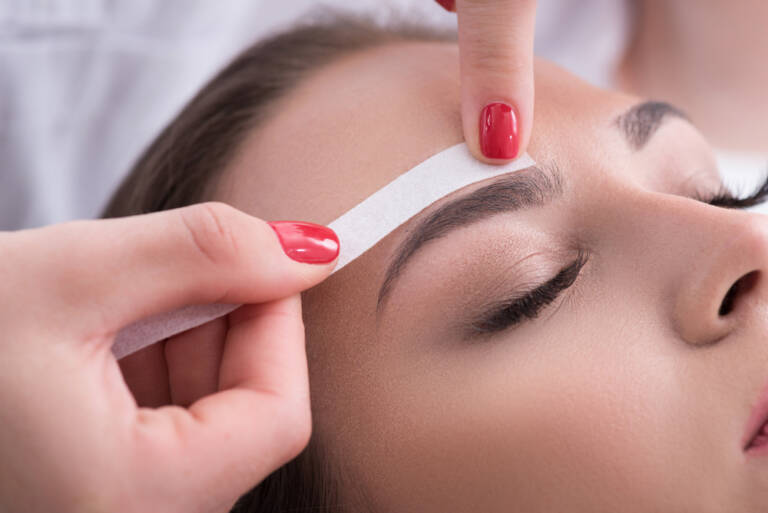 Eyebrow waxing treatment at Rowan & Peridot Collective, shaping and defining brows naturally