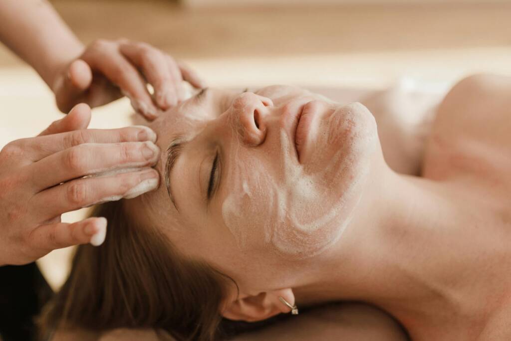 Client relaxing during a Deluxe Facial treatment