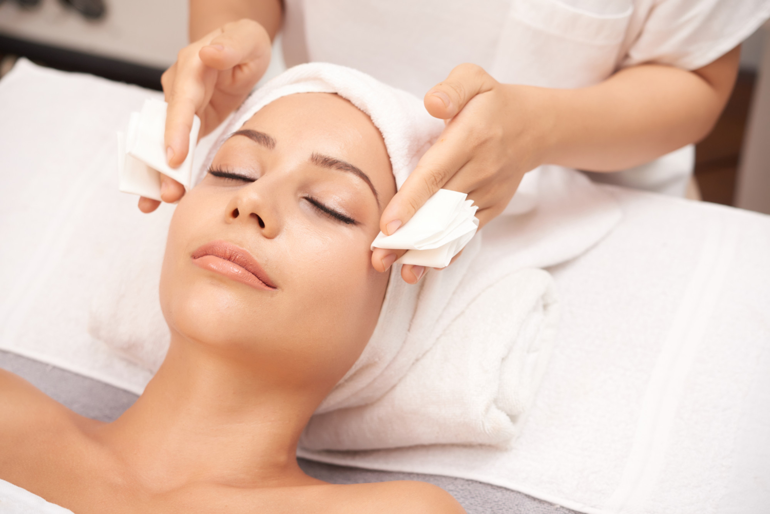 esthetician consulting with client about facial, waxing, or makeup services