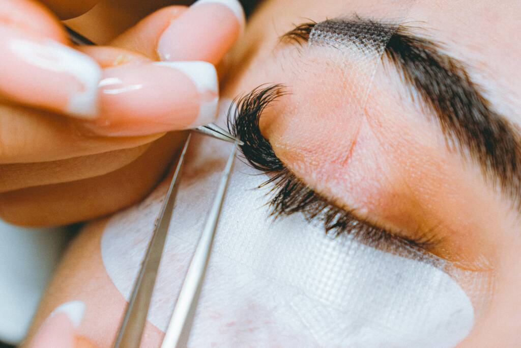 Client with naturally enhanced lashes and brows showing soft definition and balanced shaping after lash and brow treatments
