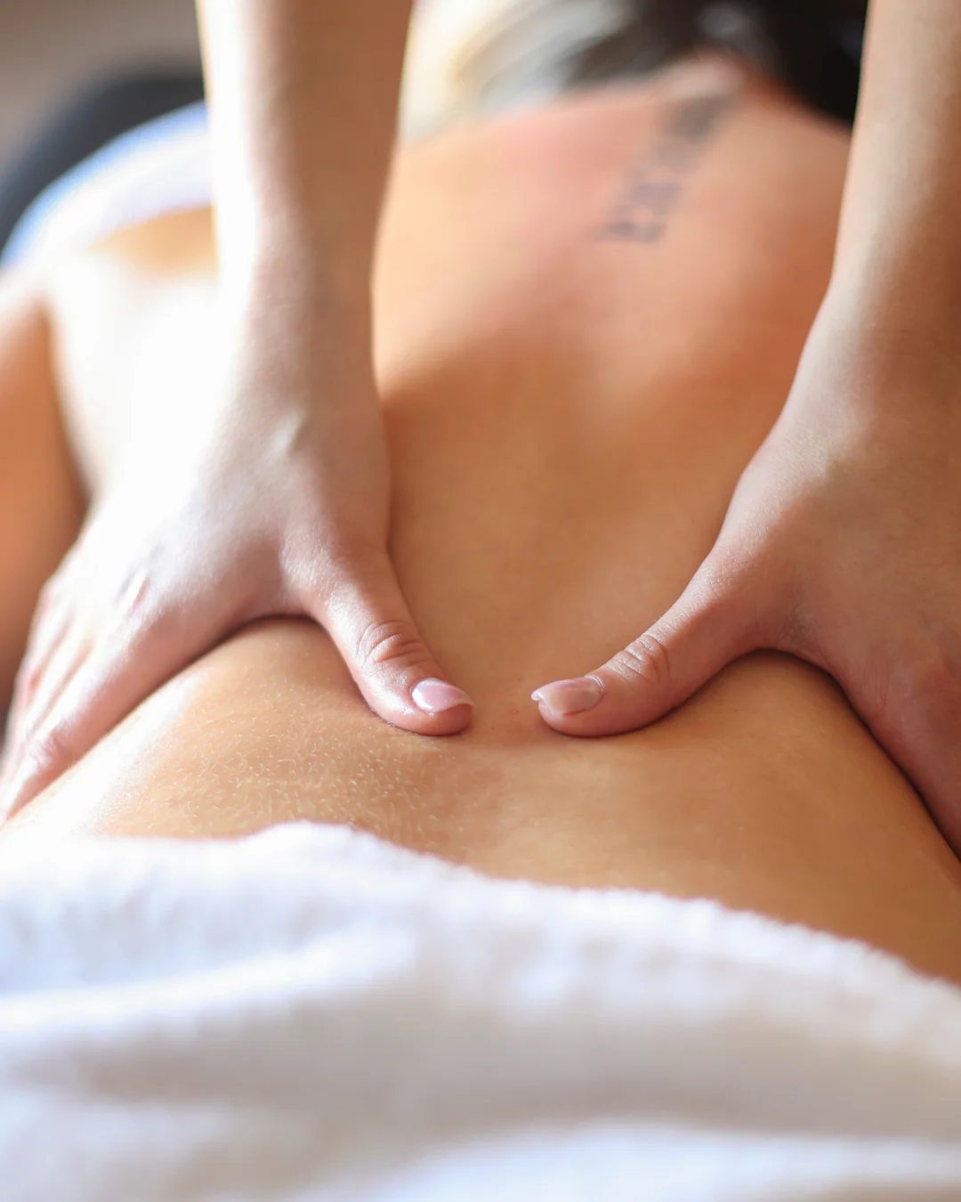 Client receiving a relaxing lymphatic massage treatment in a calm wellness studio
