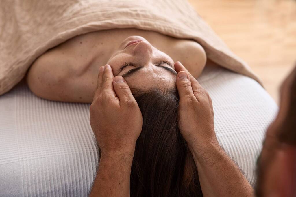Reiki energy healing session in Lethbridge with hands placed above client body