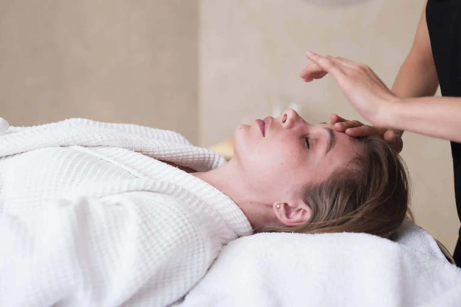 Client relaxing during a Reiki wellness session in Lethbridge