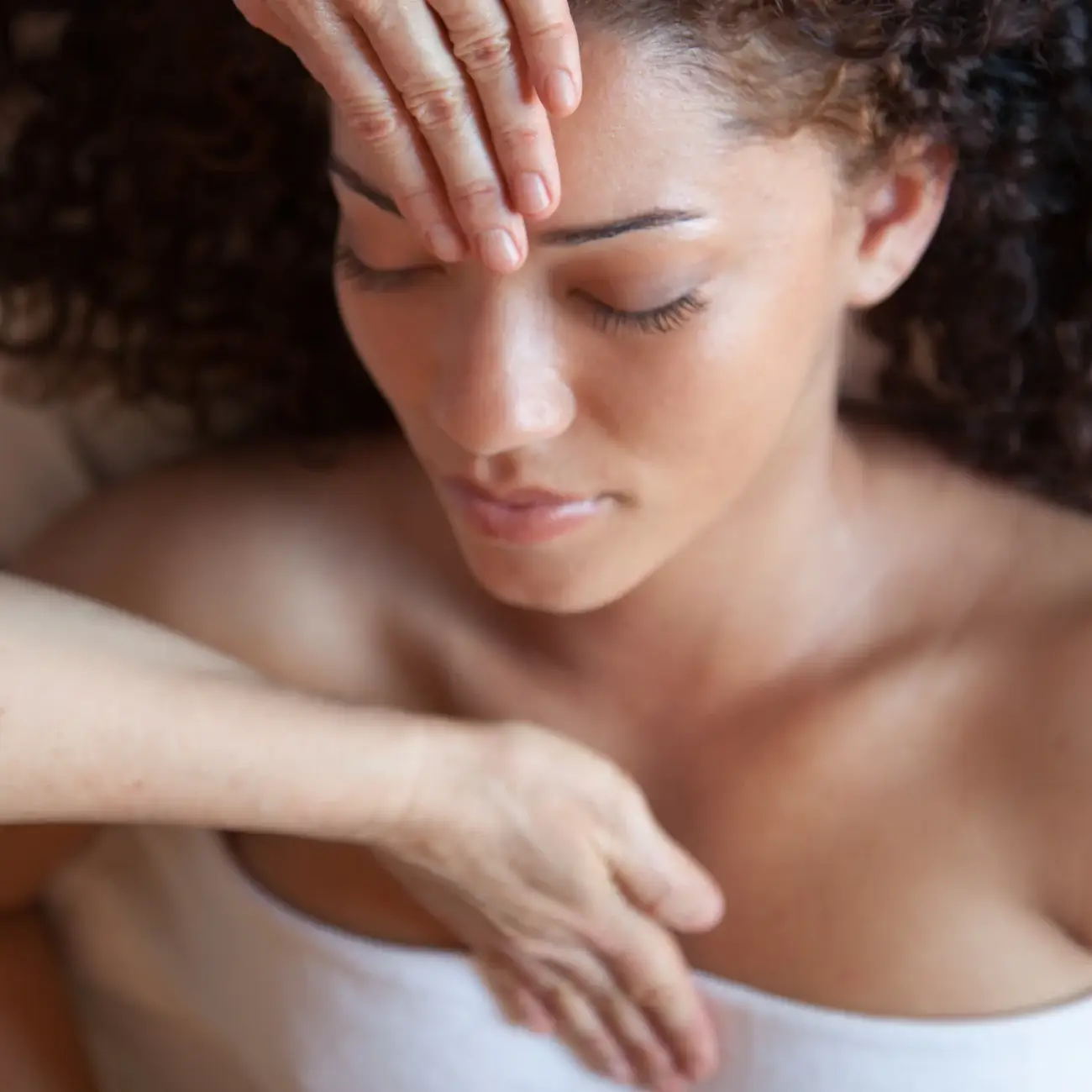 Reiki practitioner using traditional hand positions during a Reiki treatment