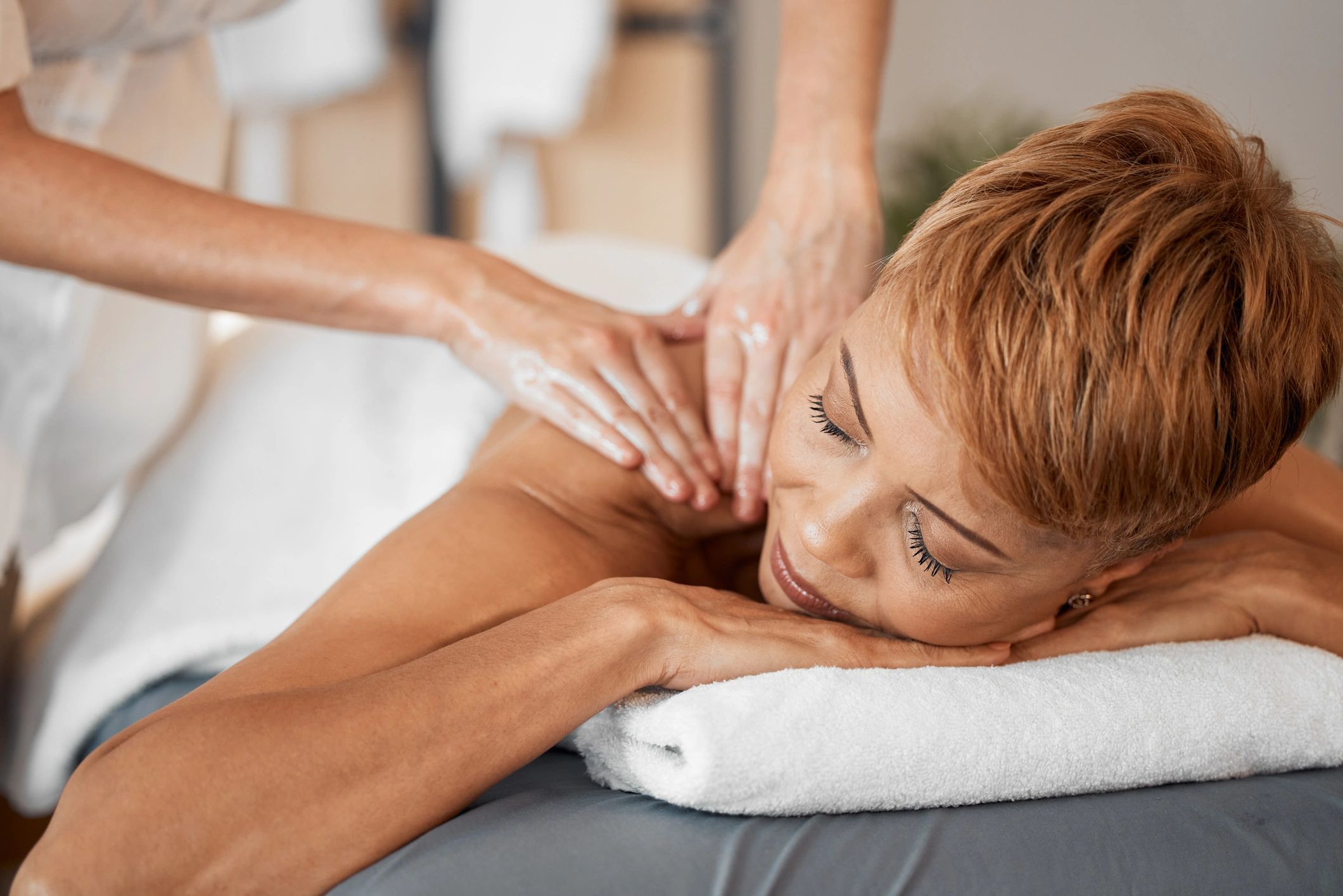 Massage therapist providing relaxing shoulder and upper back massage therapy