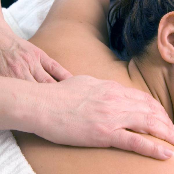 Close-up of hands applying Swedish massage techniques